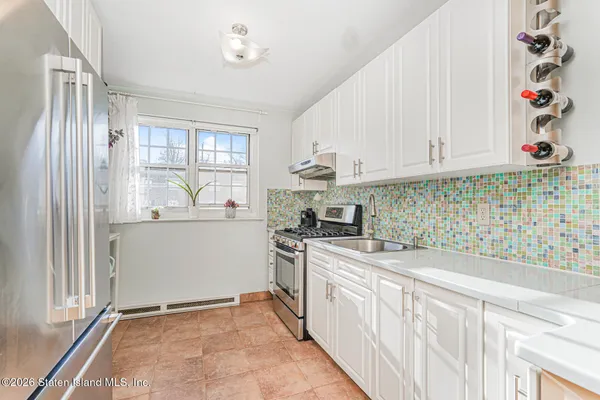 a kitchen with stainless steel appliances a stove a sink and a refrigerator