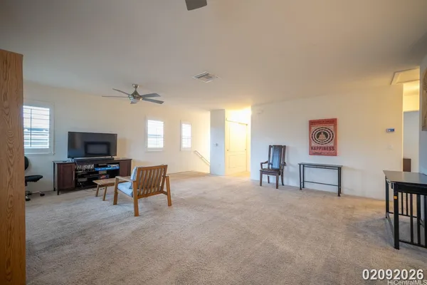 a living room with furniture wooden floor and a flat screen tv