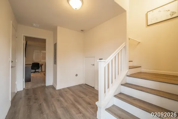 a view of a hallway with wooden floor and entryway