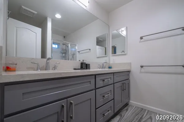 a bathroom with a double vanity sink and mirror