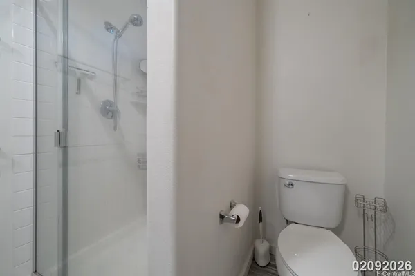 a white toilet sitting next to a bathroom sink