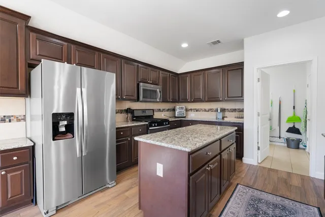 a kitchen with a stove sink and refrigerator