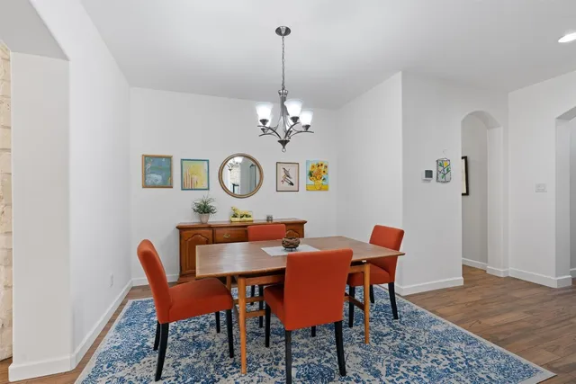 a view of a dining room with furniture and chandelier