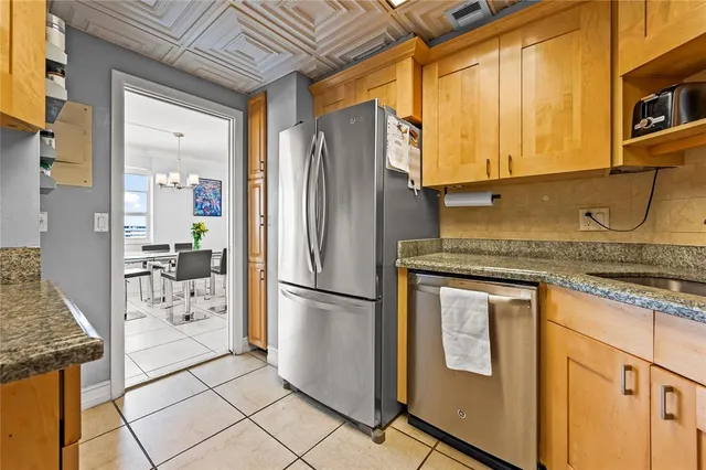 a kitchen with stainless steel appliances granite countertop a refrigerator and a stove