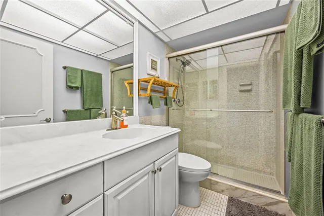a bathroom with a sink shower and a mirror
