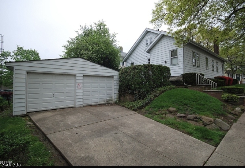 124 Overlook Avenue Belleville, NJ 07109 - Photo 2 of 4 a front view of house with yard and green space