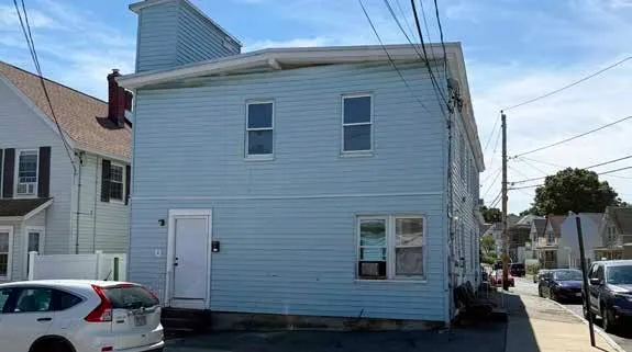 a couple of cars parked in front of a house