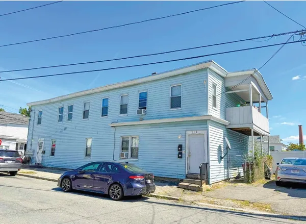 a front view of a house with parking space