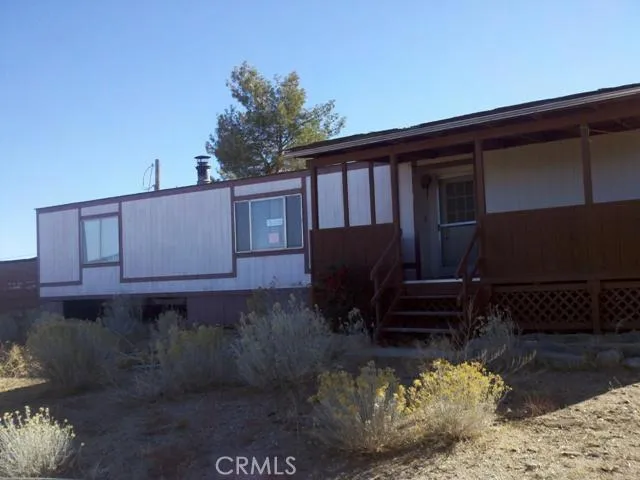 2855 Hollister Road Pinon Hills, CA 92372 - Photo 1 of 1 a front view of a house with a yard