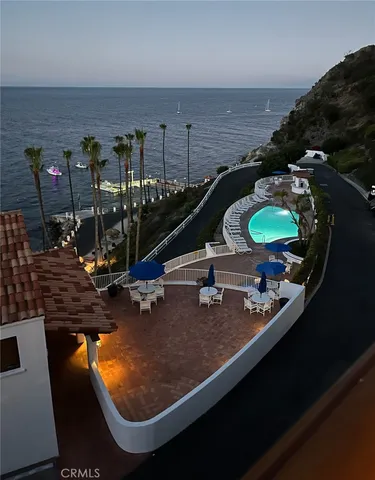 a bedroom with a bed and a flat tv screen on a dresser