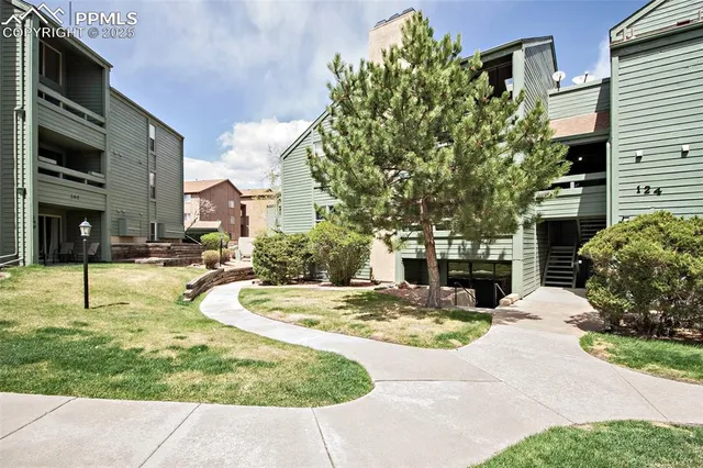 a swimming pool with some tall buildings