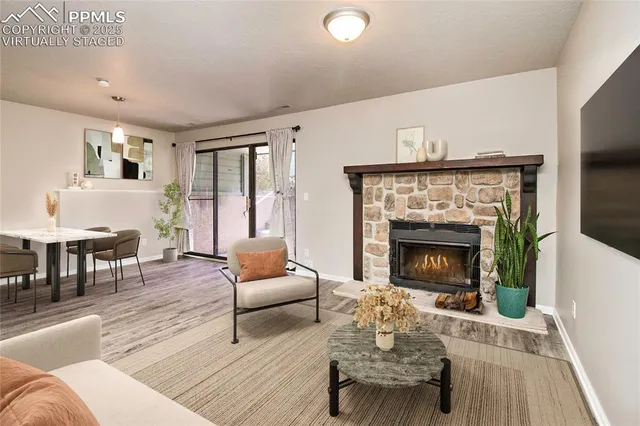 a living room with furniture and a fireplace