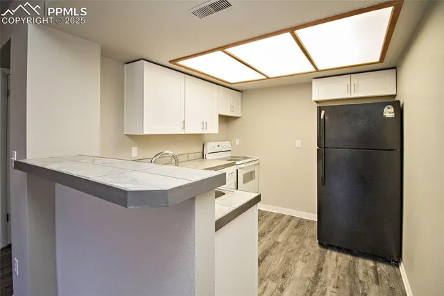 a kitchen with a refrigerator and a sink