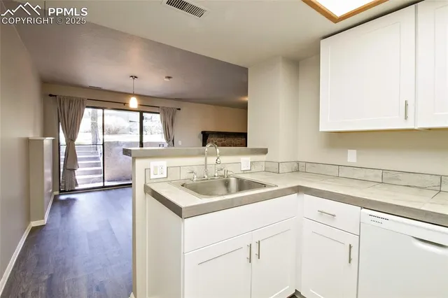 a kitchen with a sink and a window