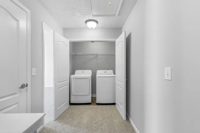 a view of a storage & utility room with a washer dryer