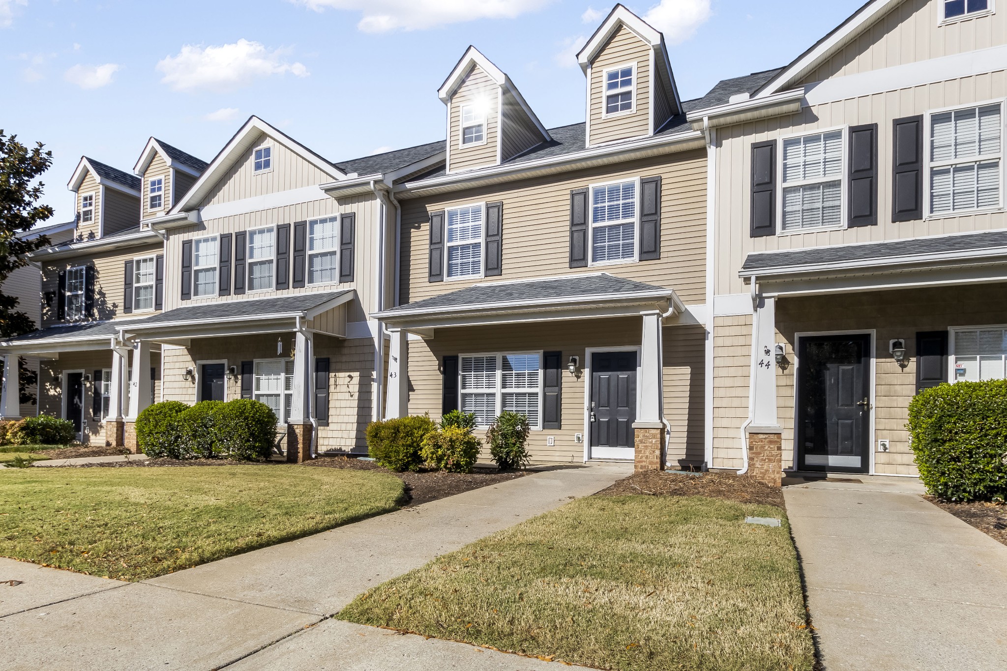 284 Meigs Drive, Unit F43 Murfreesboro, TN 37128 - Photo 2 of 25 front view of a brick house with a yard