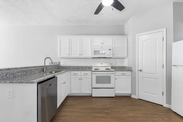 a kitchen with stainless steel appliances granite countertop a sink and a stove