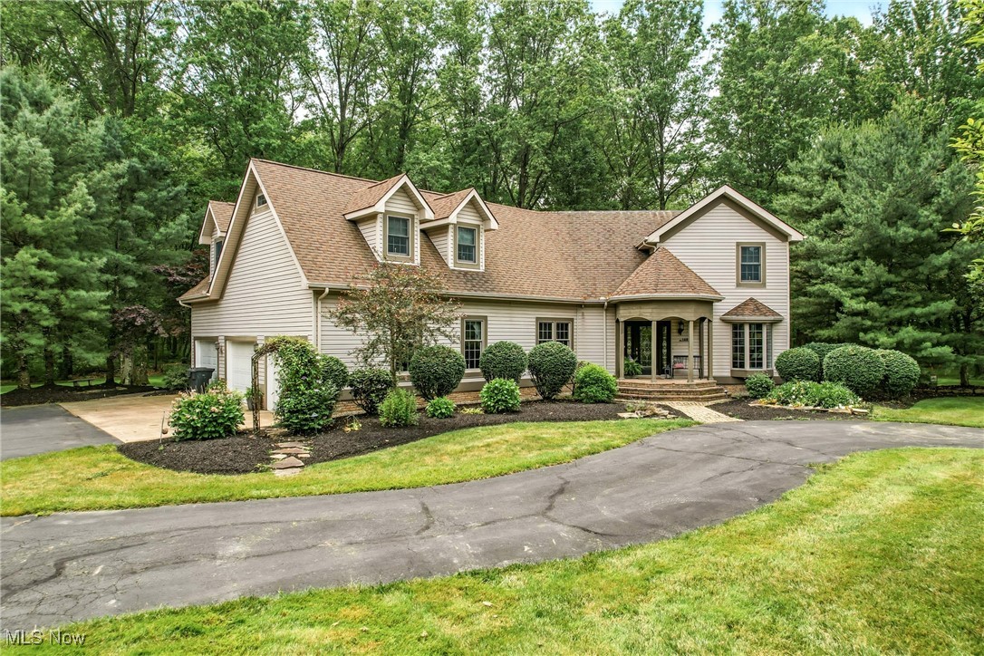 1681 State Road Northwest Warren, OH 44481 - Photo 1 of 50 View of front of home featuring a garage, driveway, a shingled roof, a front yard, and view of scattered trees