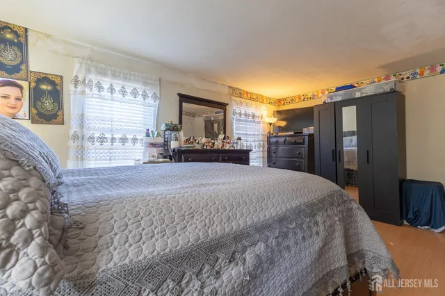 a bedroom with a bed and a dresser