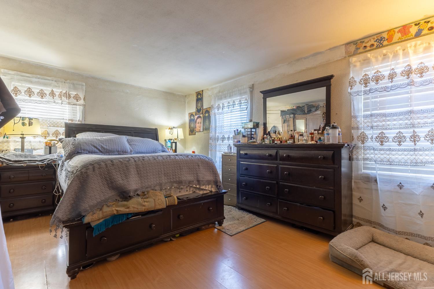 48 Locust Street Carteret, NJ 07008 - Photo 15 of 27 a bedroom with a bed and a dresser