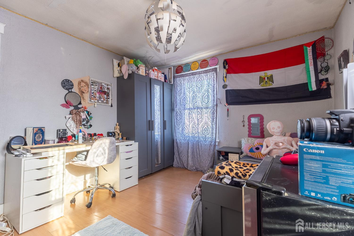 48 Locust Street Carteret, NJ 07008 - Photo 17 of 27 a bedroom with furniture and a chandelier