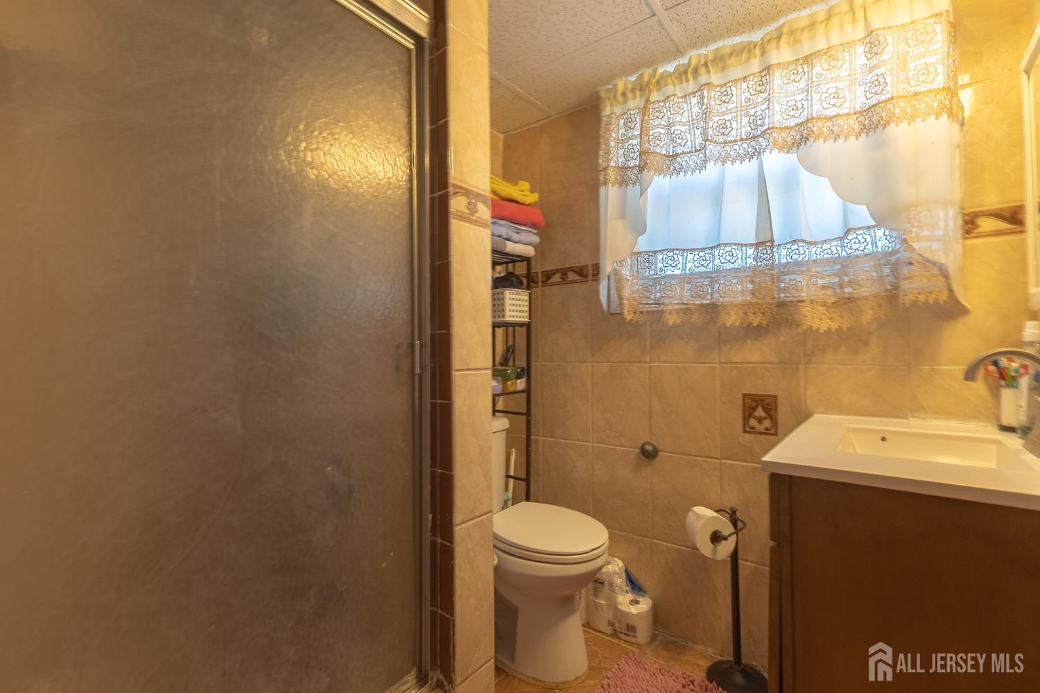 48 Locust Street Carteret, NJ 07008 - Photo 19 of 27 a bathroom with a toilet and a shower