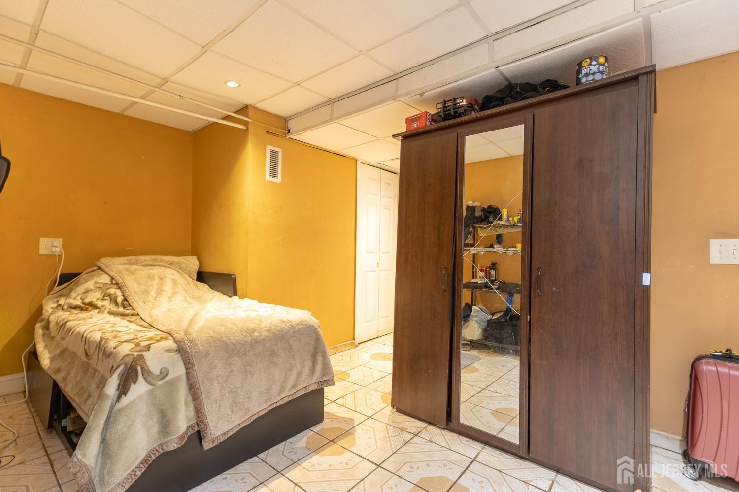 48 Locust Street Carteret, NJ 07008 - Photo 20 of 27 a bedroom with a bed and a mirror