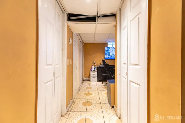 a work room with furniture and a flat screen tv