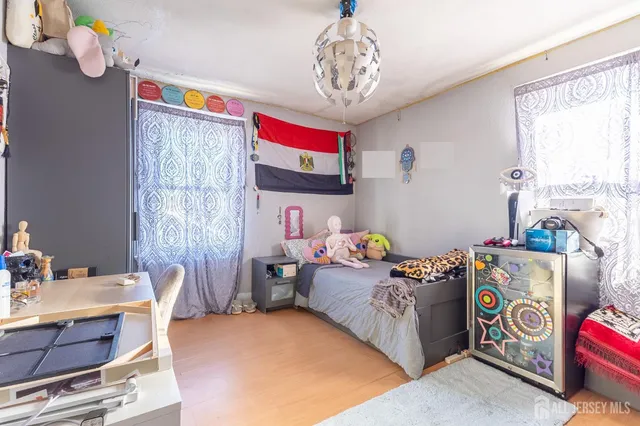 a bedroom with bed and a flat tv screen