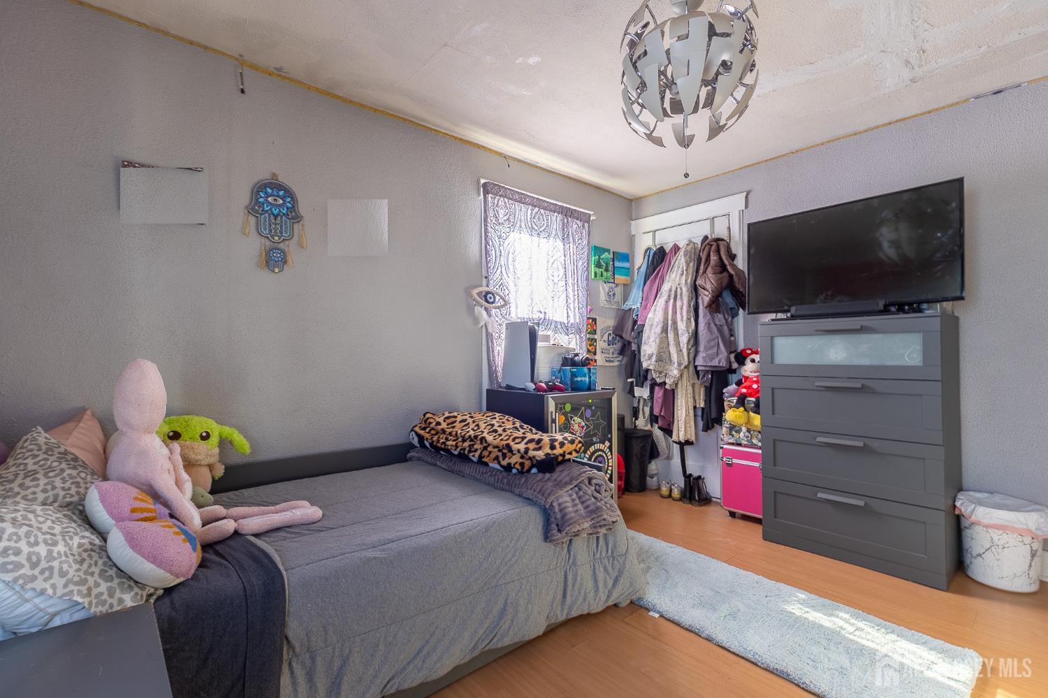 48 Locust Street Carteret, NJ 07008 - Photo 27 of 27 a bedroom with bed and a flat tv screen