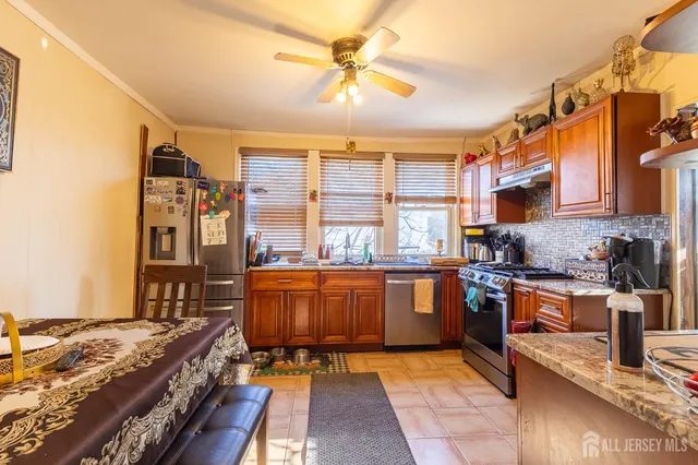 a kitchen with stainless steel appliances granite countertop a stove and cabinets