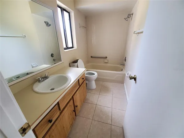 a bathroom with a sink toilet and mirror