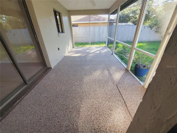 a view of a backyard with furniture and wooden floor