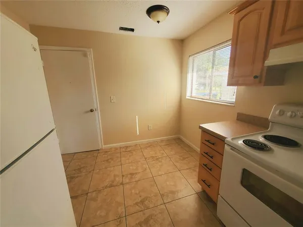 a kitchen with a stove and a refrigerator