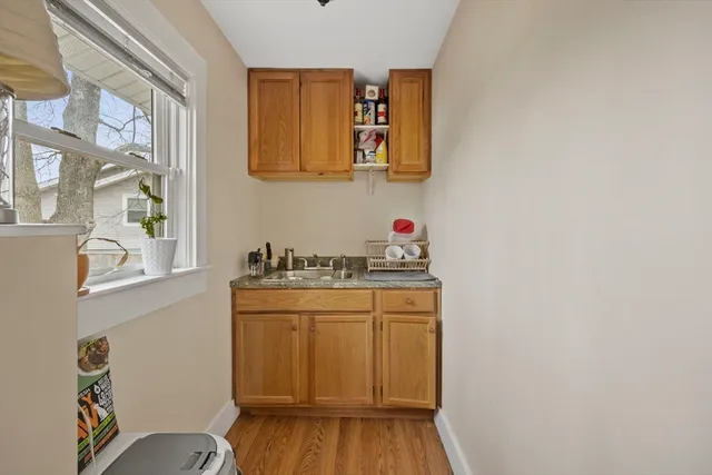 a utility room with cabinets washer and dryer