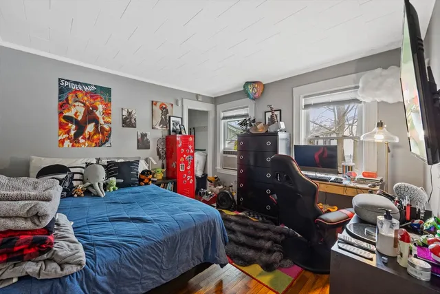 a bedroom with furniture and a flat screen tv