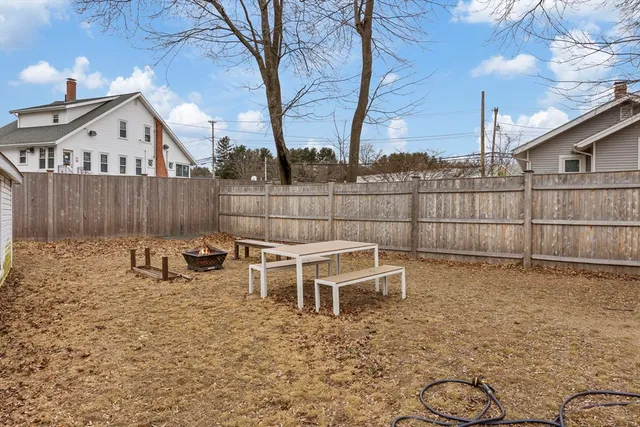a view of a brick house with wooden fence