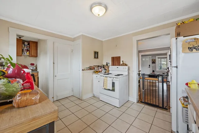a kitchen that has a lot of cabinets in it and wooden floors
