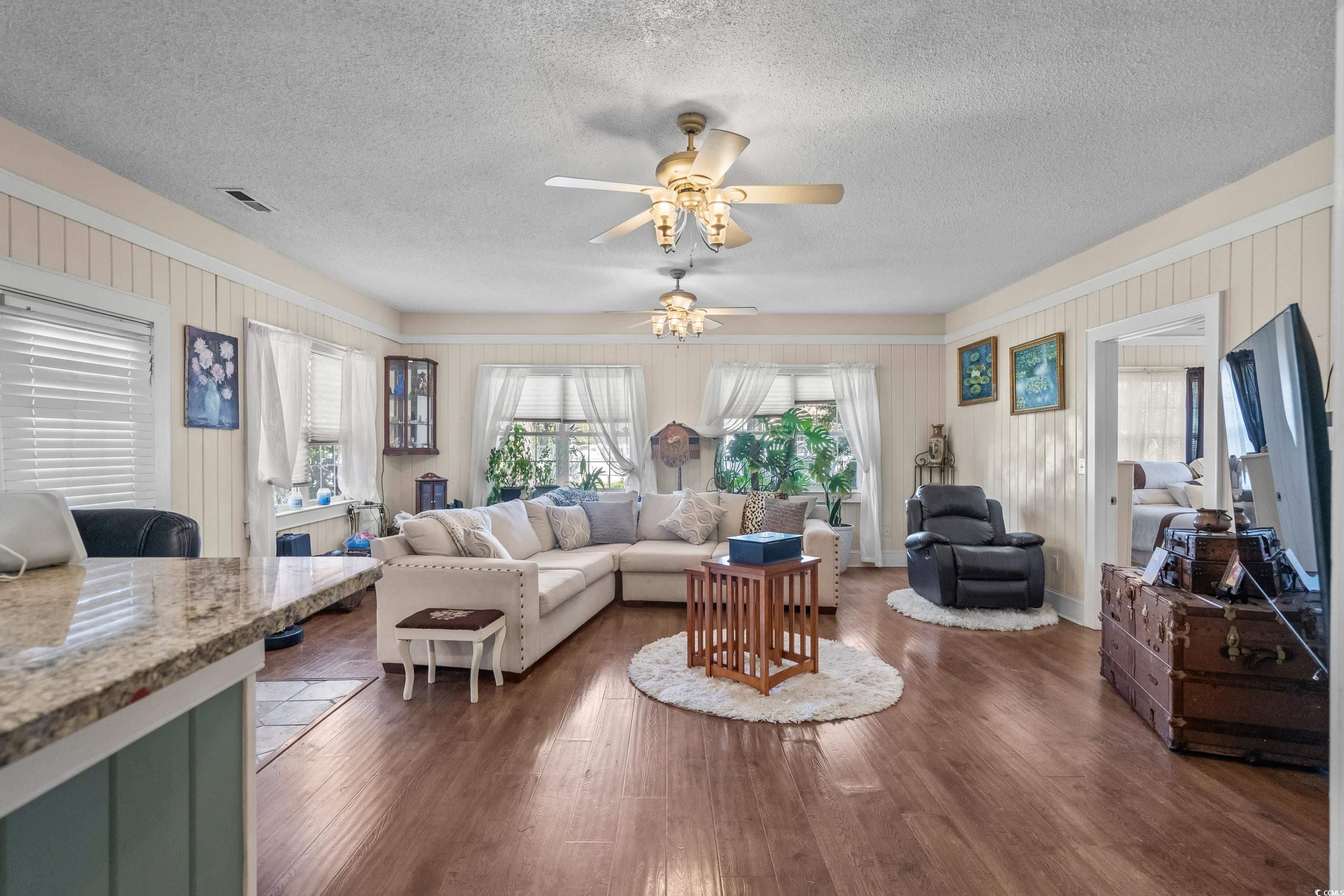 159 Brookgate Drive Myrtle Beach, SC 29579 - Photo 13 of 40 Living area featuring dark wood finished floors, a textured ceiling, and a ceiling fan