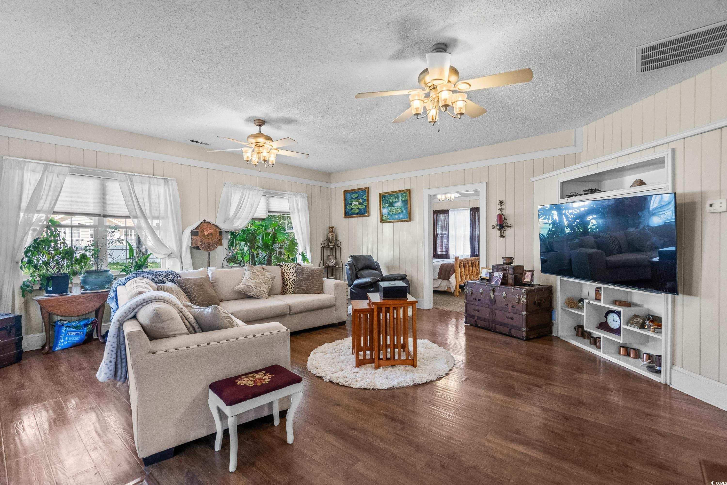 159 Brookgate Drive Myrtle Beach, SC 29579 - Photo 14 of 40 Living room with wood finished floors, a ceiling fan, and a textured ceiling