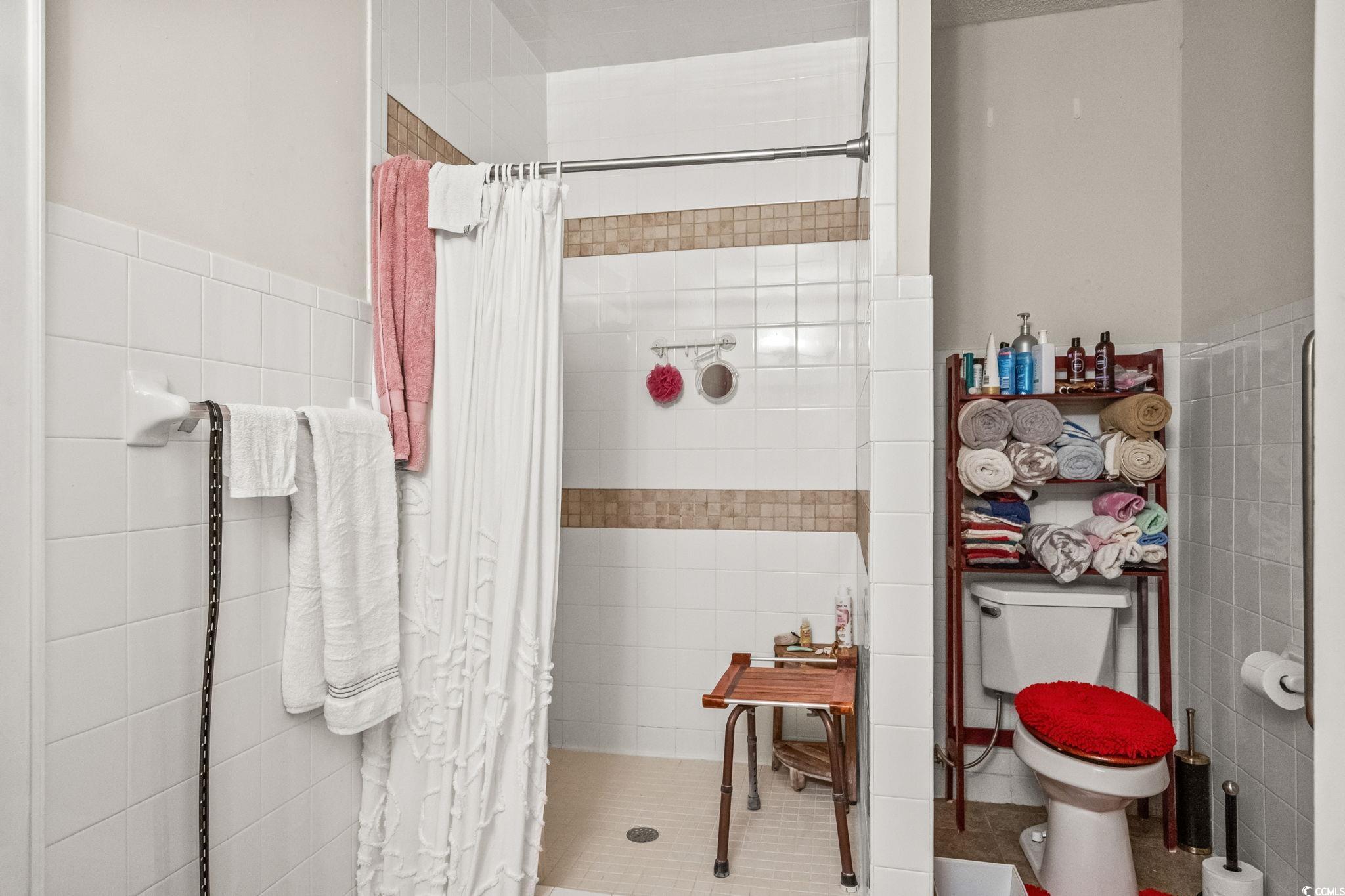 159 Brookgate Drive Myrtle Beach, SC 29579 - Photo 18 of 40 Bathroom featuring tile walls and a shower stall