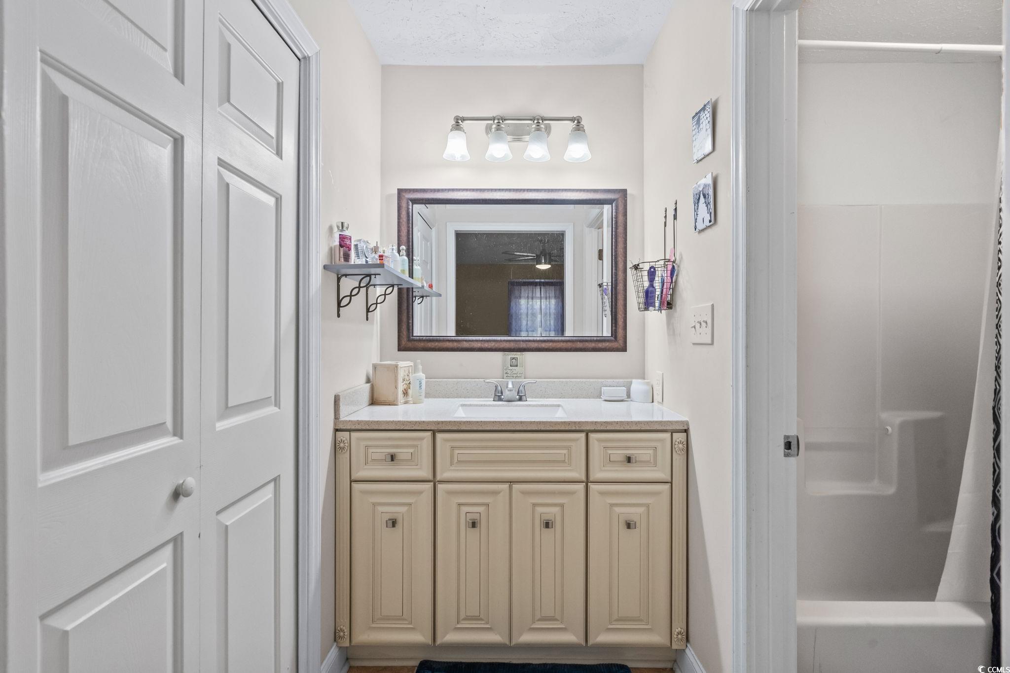 159 Brookgate Drive Myrtle Beach, SC 29579 - Photo 21 of 40 Full bath featuring vanity, shower / bath combination with curtain, and a textured ceiling