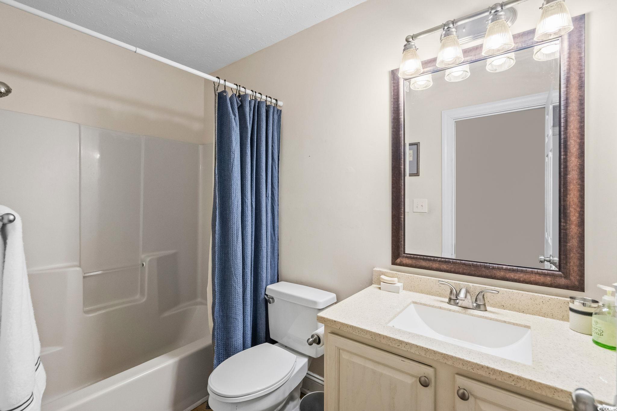 159 Brookgate Drive Myrtle Beach, SC 29579 - Photo 22 of 40 Full bathroom with shower / bath combo, vanity, and a textured ceiling