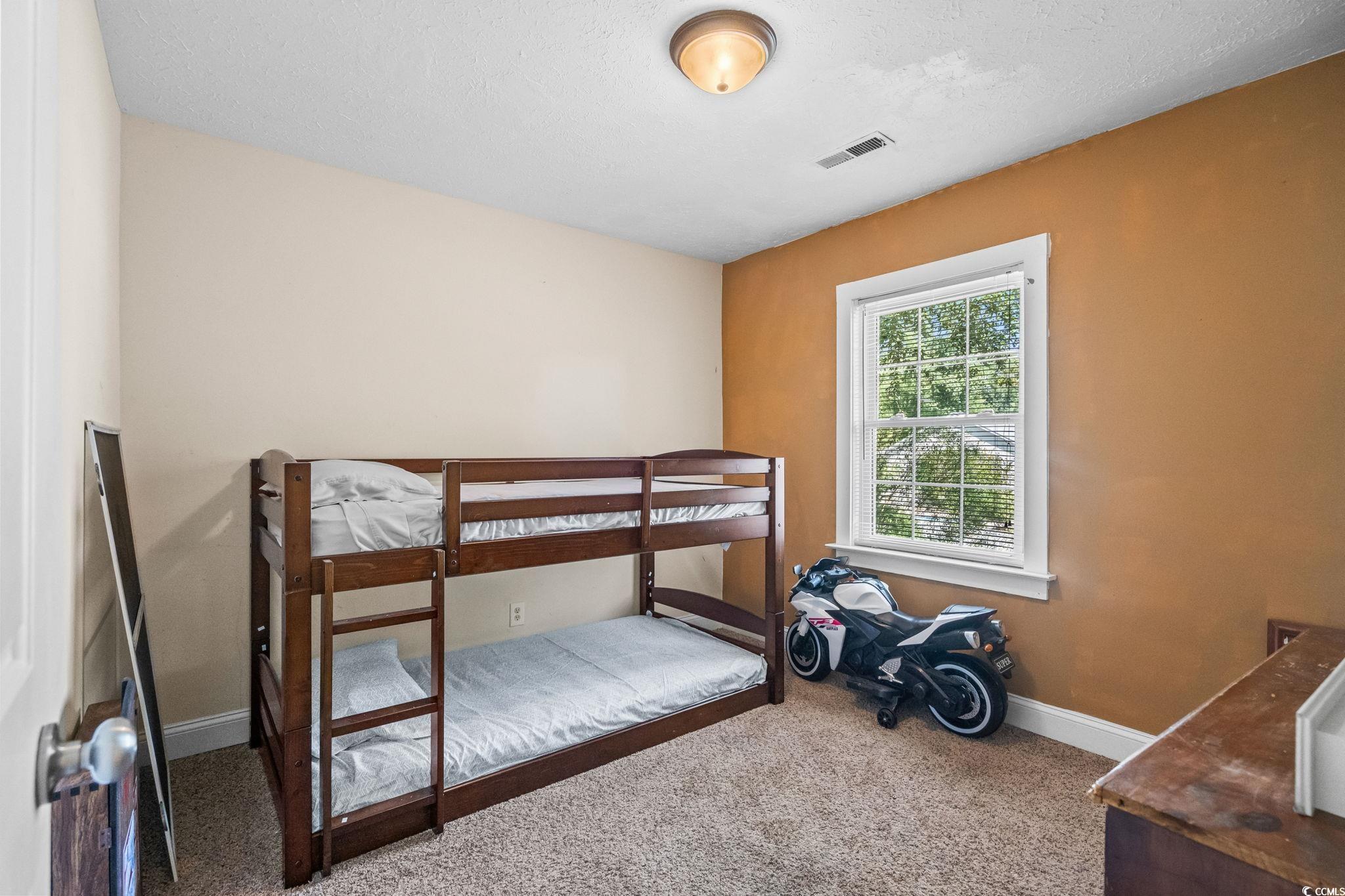 159 Brookgate Drive Myrtle Beach, SC 29579 - Photo 24 of 40 Carpeted bedroom featuring baseboards and a textured ceiling