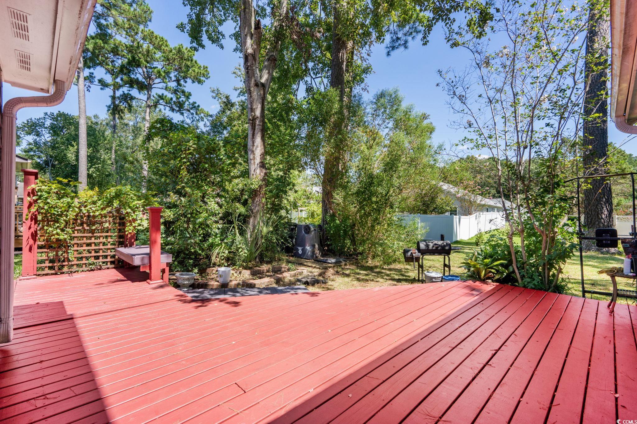 159 Brookgate Drive Myrtle Beach, SC 29579 - Photo 27 of 40 Wooden deck with a fenced backyard and view of wooded area