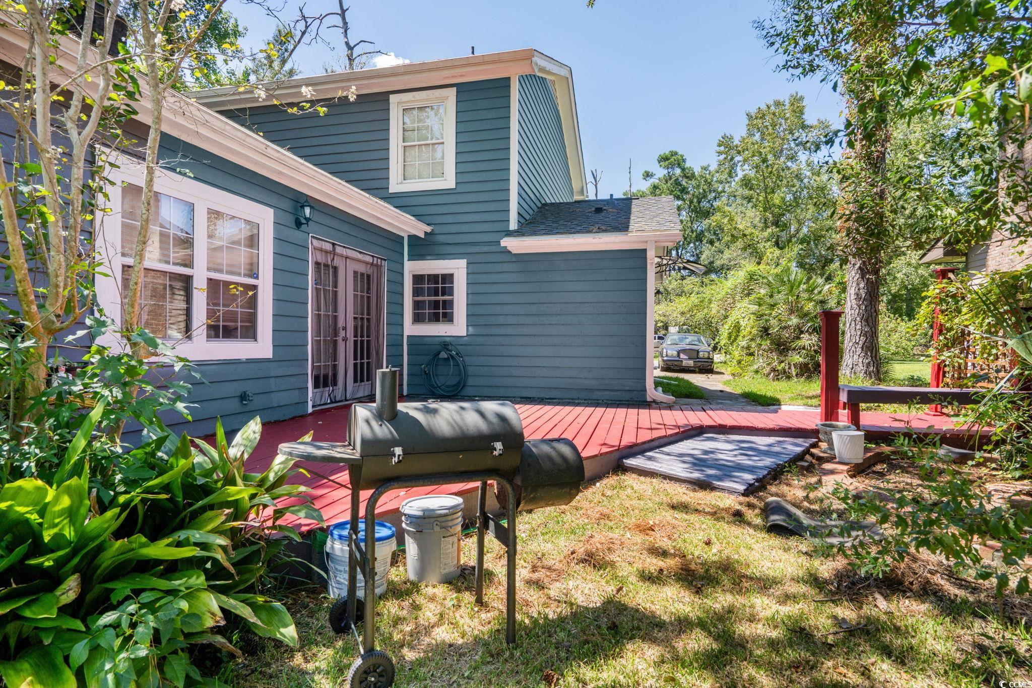159 Brookgate Drive Myrtle Beach, SC 29579 - Photo 29 of 40 Back of house with a deck, roof with shingles, and a lawn