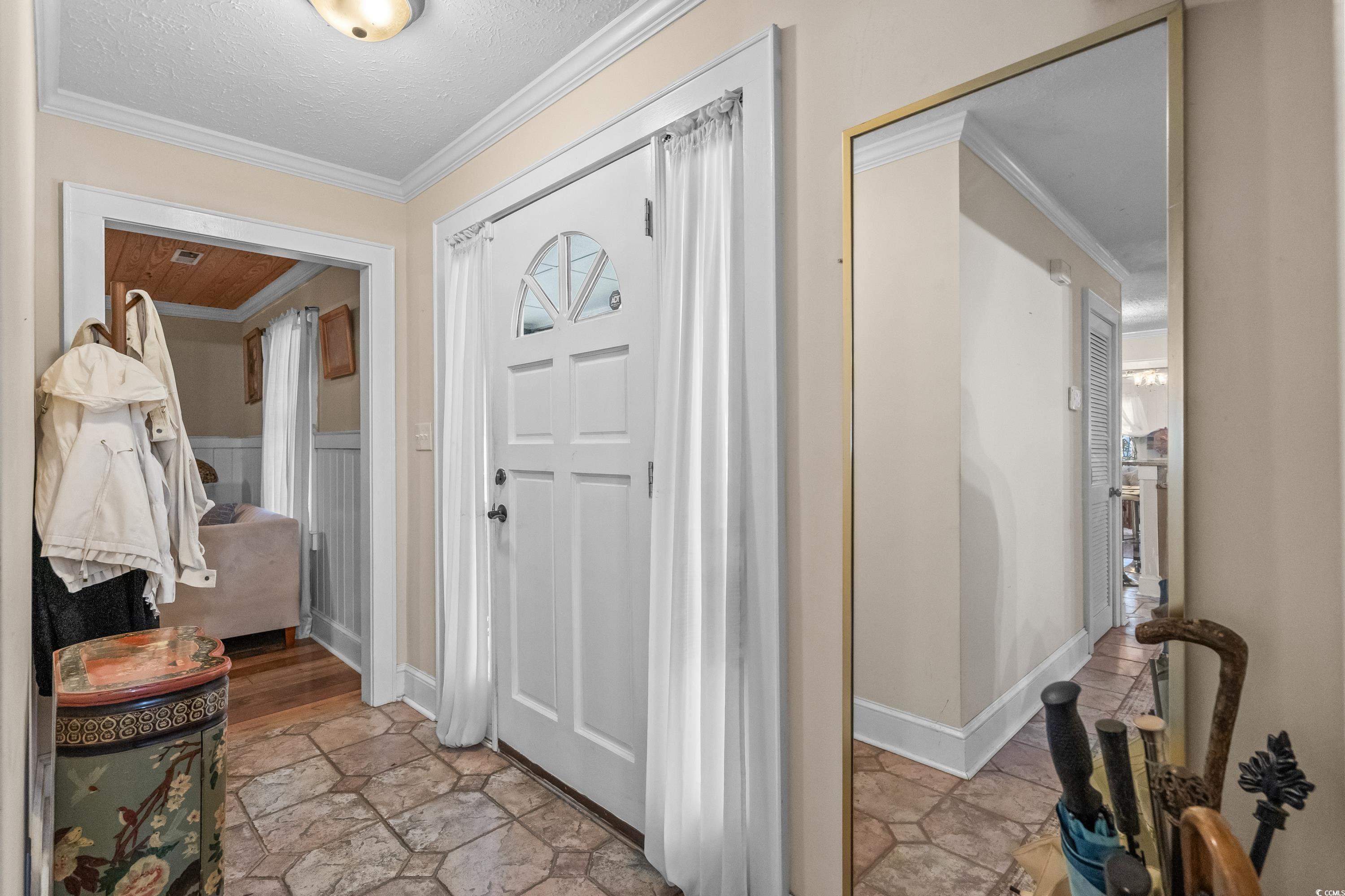 159 Brookgate Drive Myrtle Beach, SC 29579 - Photo 4 of 40 Foyer with crown molding, stone tile flooring, and a textured ceiling