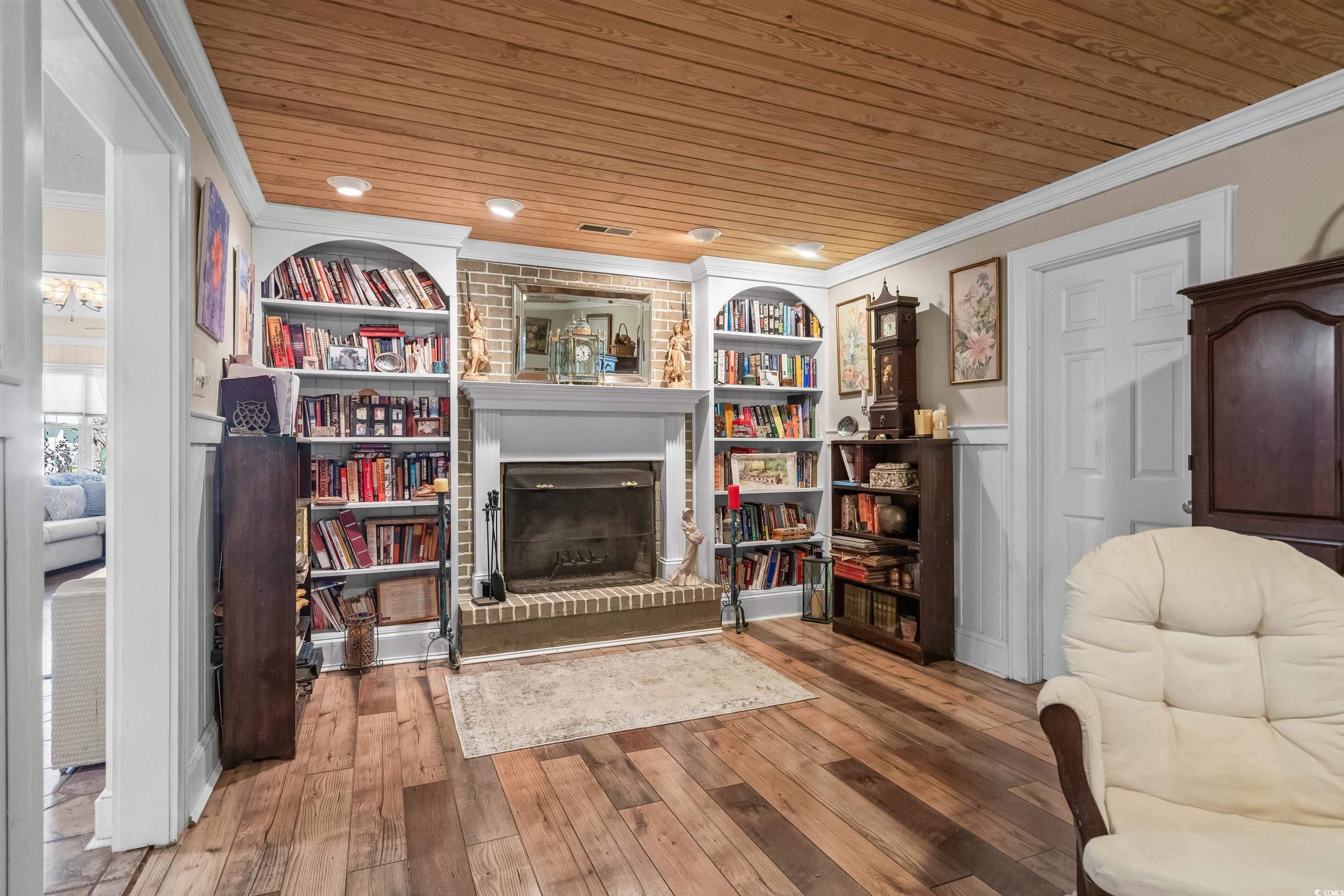 159 Brookgate Drive Myrtle Beach, SC 29579 - Photo 8 of 40 Sitting room featuring crown molding, wood ceiling, light wood-type flooring, a brick fireplace, and recessed lighting