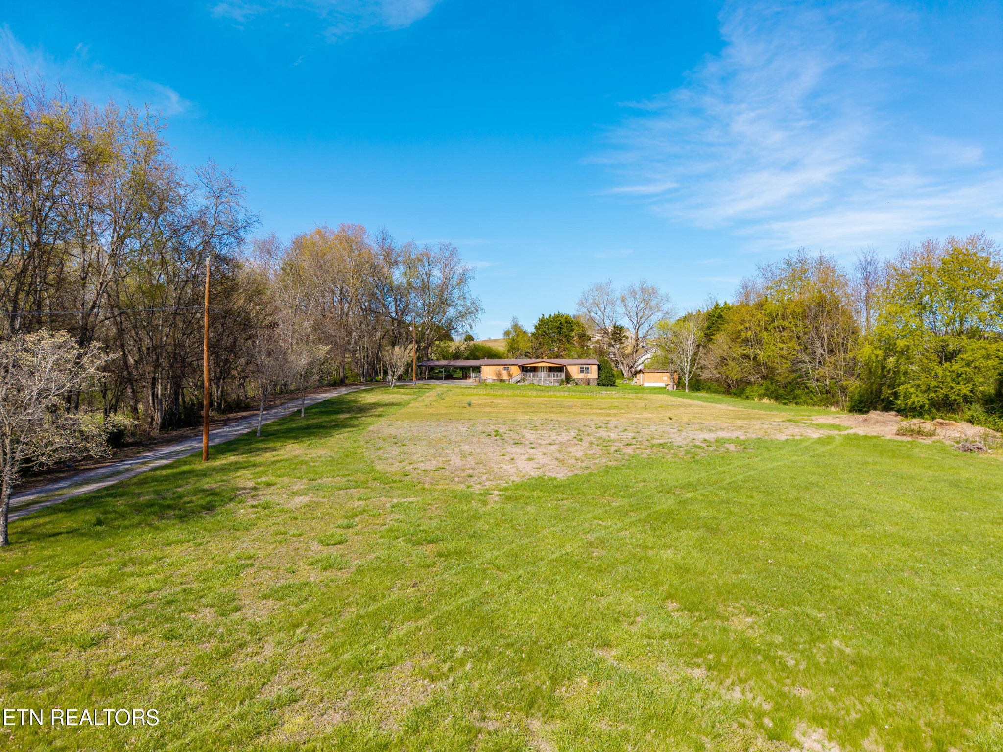 337 River Ford Road Maryville, TN 37804 - Photo 28 of 33 a view of swimming pool with an outdoor seating and house in the background