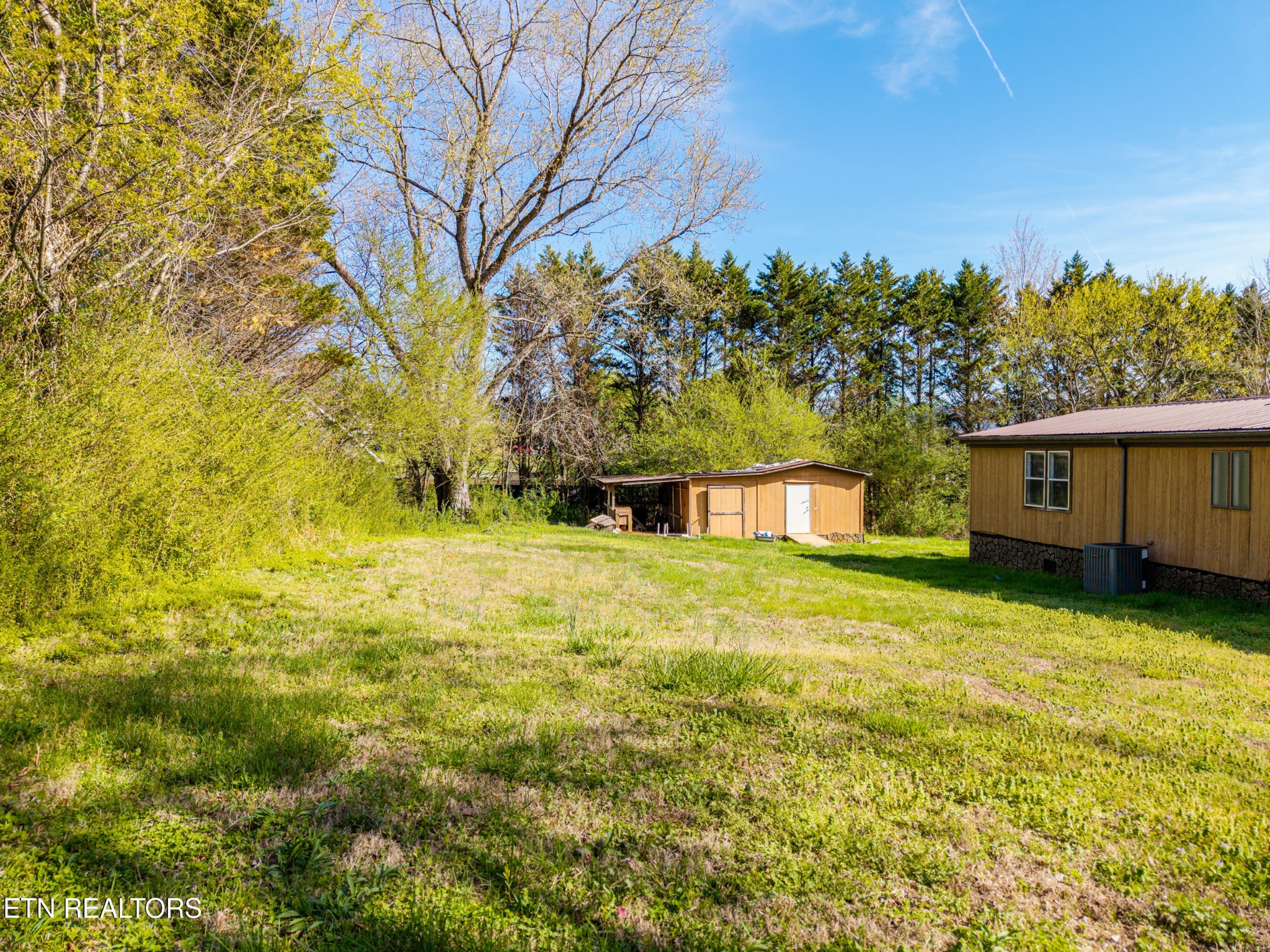 337 River Ford Road Maryville, TN 37804 - Photo 9 of 33 a yellow house sitting in middle of the garden